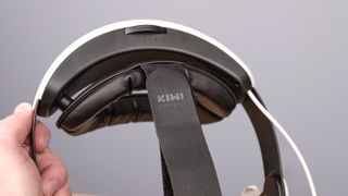 Rear of Kiwi Design H4 Boost Halo Battery Strap in hand showing adjustable dial