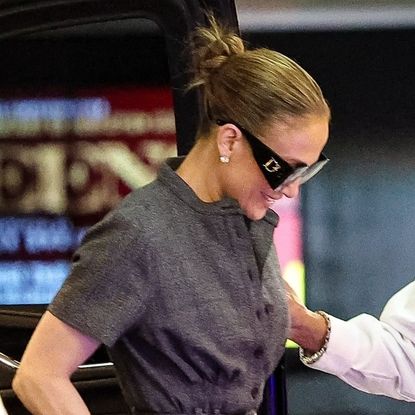 Jennifer Lopez wearing a chic gray shirt dress with platform heels while in Los Angeles May 2024