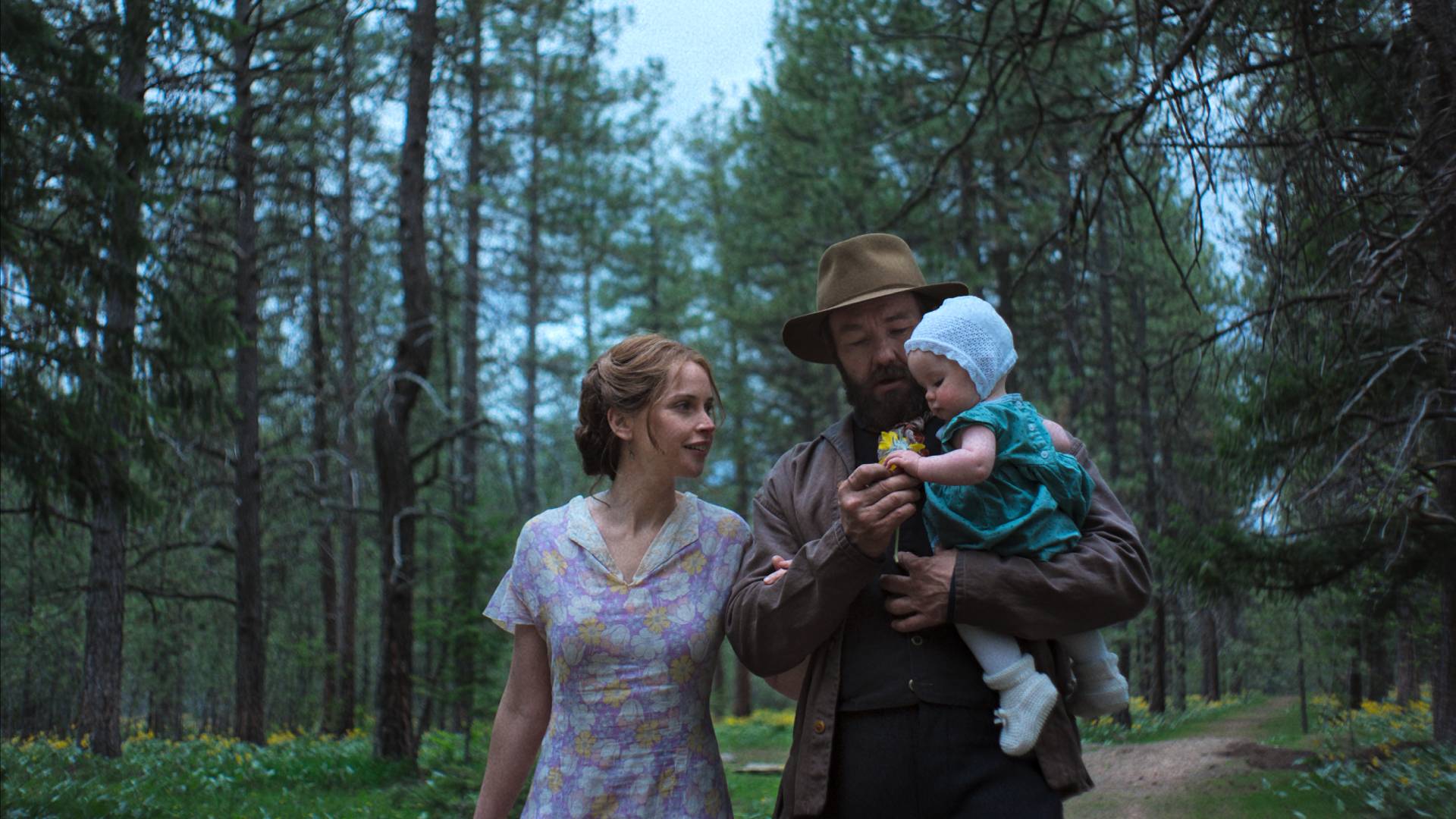Joel Edgerton and Felicity Jones with a baby in Train Dreams