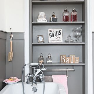 bathroom with grey shelves and bathtub