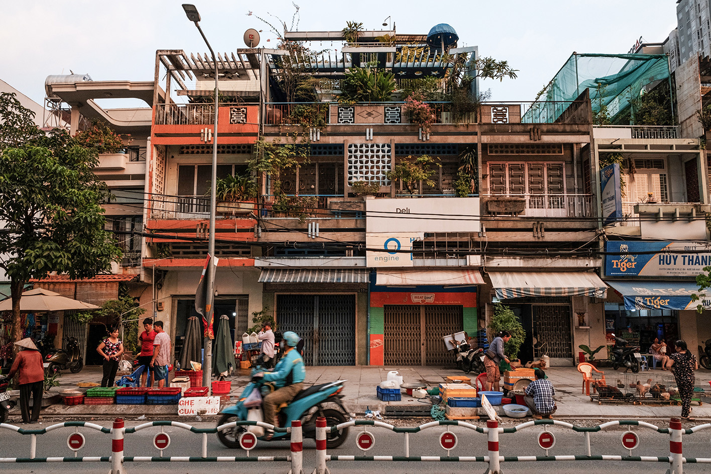 busy street with background of shophouse buildings in Vietnamese modernist architecture