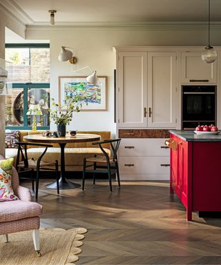 kitchen with wooden floor and seating corner with banquette and red island