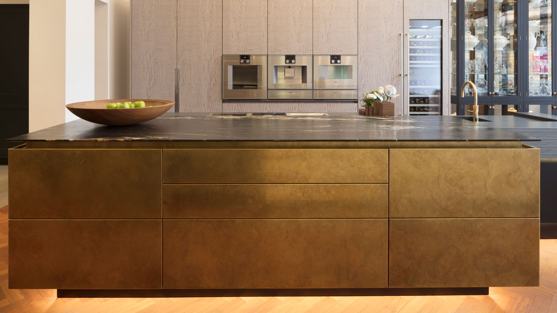 metallic industrial kitchen with glass countertops and handleless doors