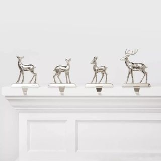 4ct Metal Reindeer Christmas Stocking Holder on a white mantel.