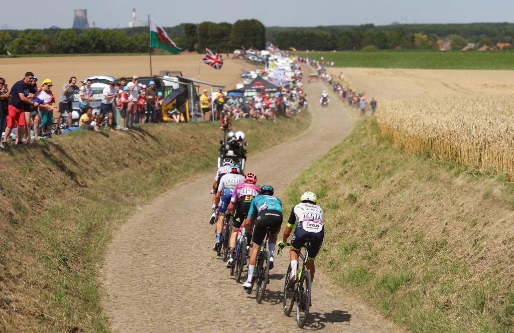 A breakaway cycles across a cobblestone sector during the 5th stage of the 109th edition of the Tour de France cycling race 1537 km between Lille and Arenberg Porte du Hainaut in northern France on July 6 2022 Photo by Thomas SAMSON AFP Photo by THOMAS SAMSONAFP via Getty Images