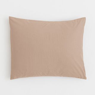 A pale pink cotton pillowcase