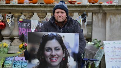 Richard Ratcliffe holds a photo of his wife