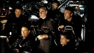 a group of scientists in a vessel crowding together in the movie the core