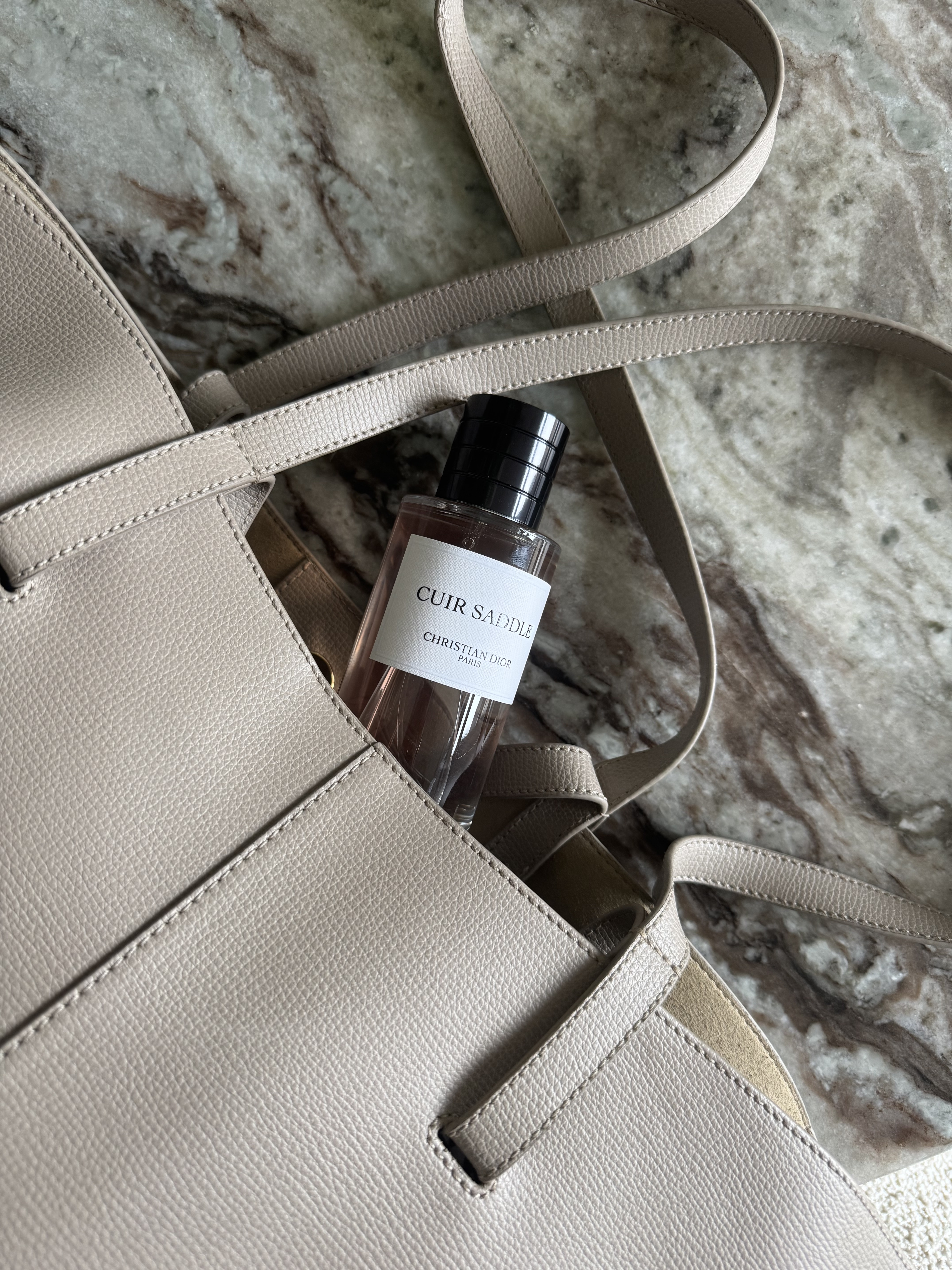 Dior Cuir Saddle perfume bottle in a leather bag