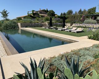 The view of an infinity pool in a garden in Tuscany
