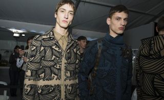 2 male models in a studio wearing Louis Vuitton outerwear