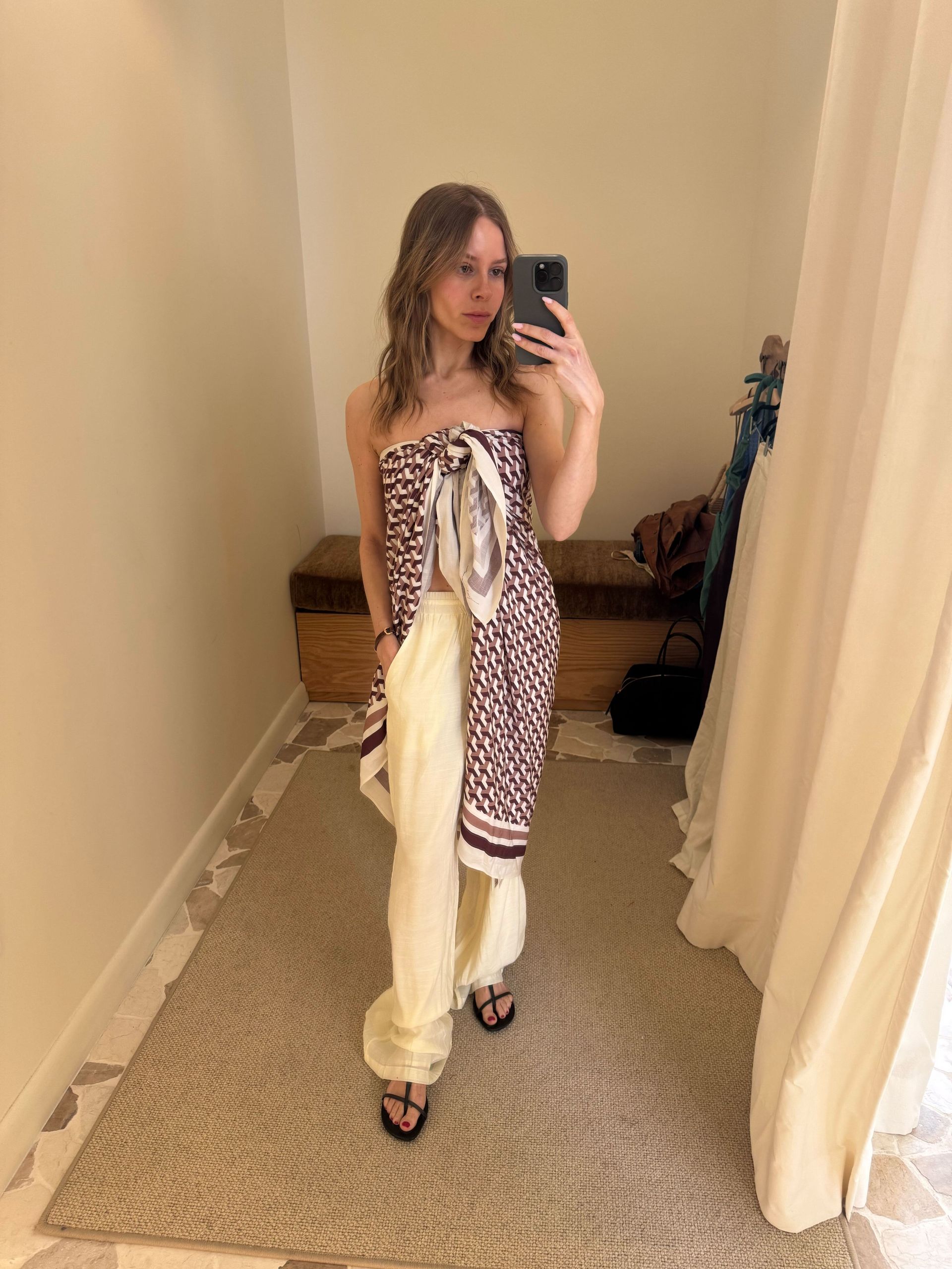 Nikki wears a scarf top with ivory pants.