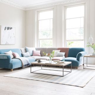 living room with white wall designed sofa with cushions