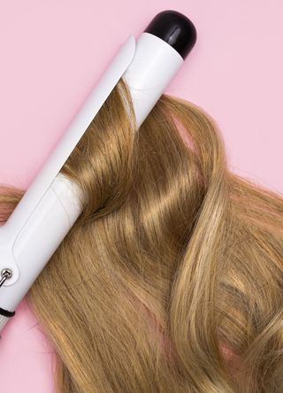 Woman using curling tongs