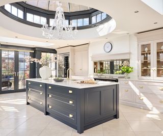 kitchen orangery extension with round rooflight above a dark and light grey kitchen island