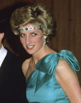 melbourne, australia october 31 prince charles, prince of wales and diana, princess of wales, wearing a green satin evening dress designed by david and elizabeth emanuel and an emerald necklace as a headband, attend a gala dinner dance at the southern cross hotel on october 31, 1985 in melbourne, australia photo by anwar husseingetty images