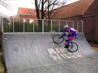 Bjorn Selander trying to catch air on a half pipe in a Belgian park