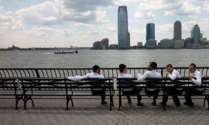 Young Jews sit near the Hudson River in New York