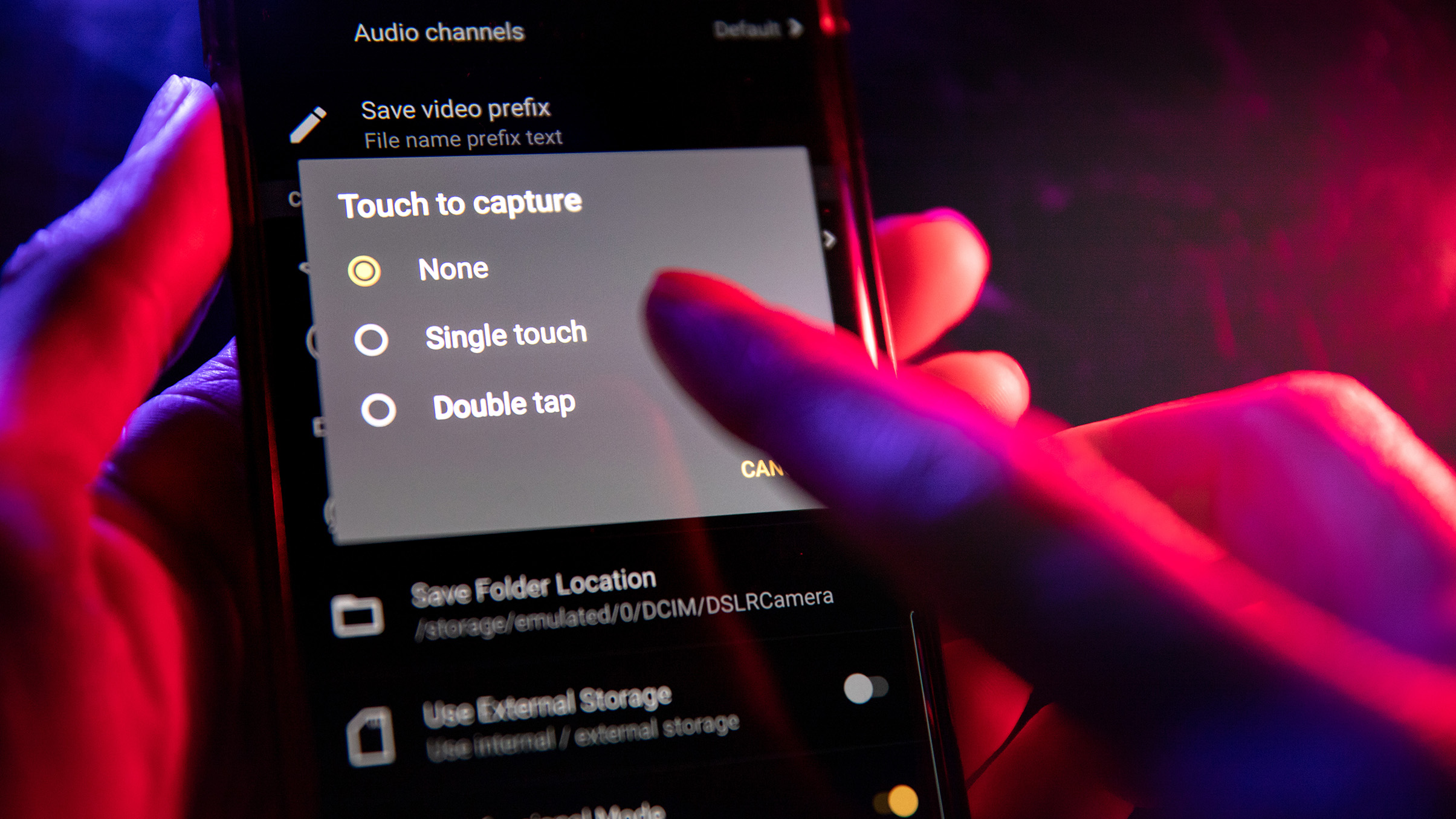 A hand selects capture options on a smartphone screen, displaying settings for touch capture modes: none, single touch, and double tap