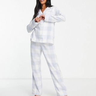 model wearing Lindex Exclusive Petite revere top and trouser pyjama set in blue check print