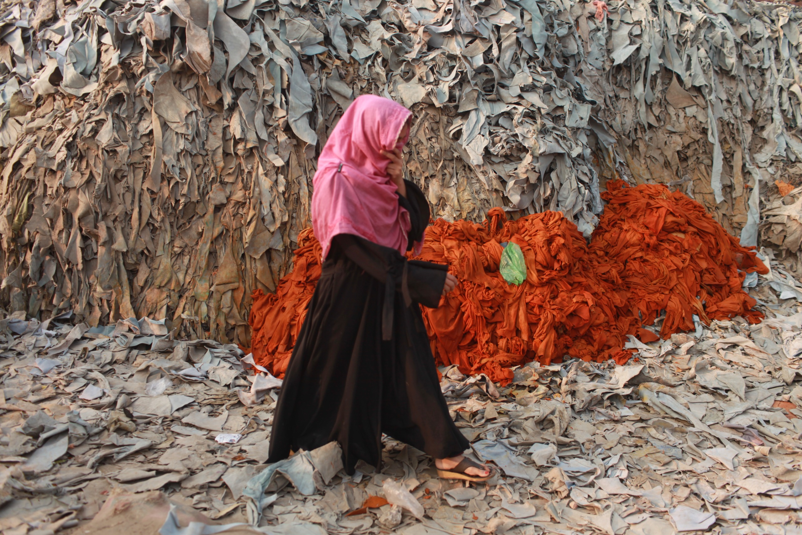 woman walks through Tannery In Bangladesh.