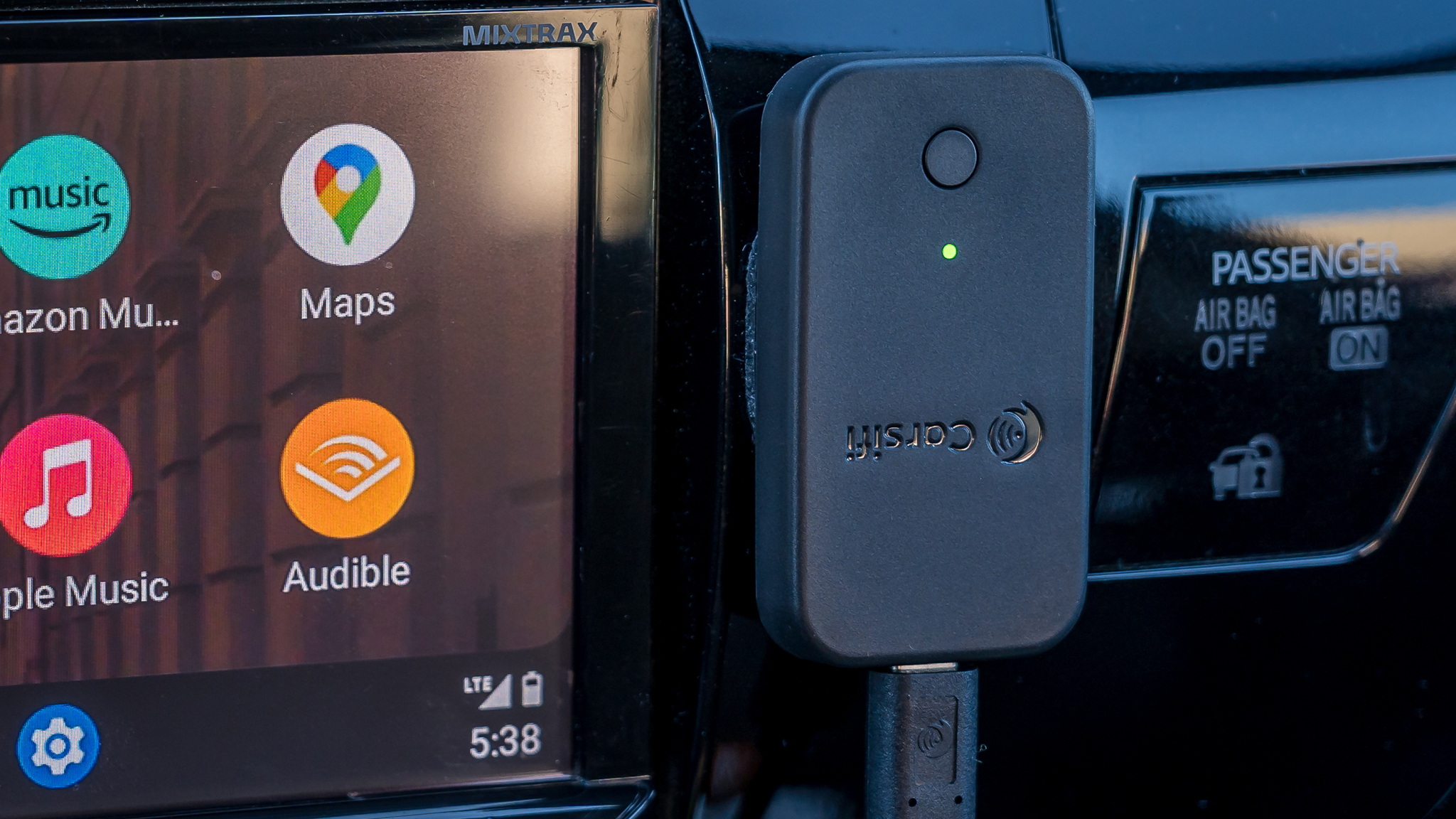Close-up of Carsifi Android Auto adapter stuck to dashboard.