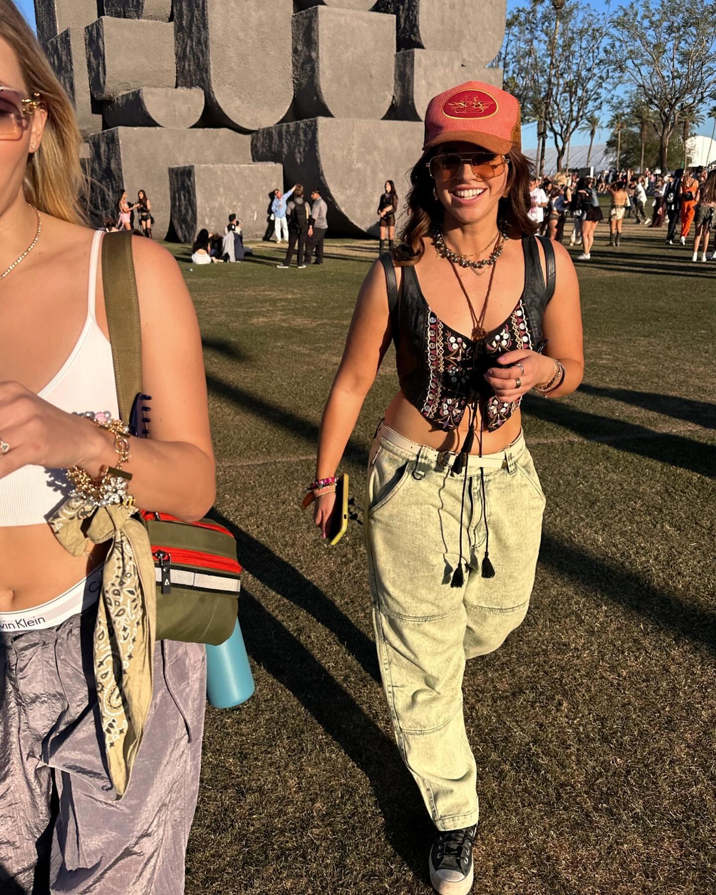 vanessa wears a vest and baggy jeans at coachella music festival
