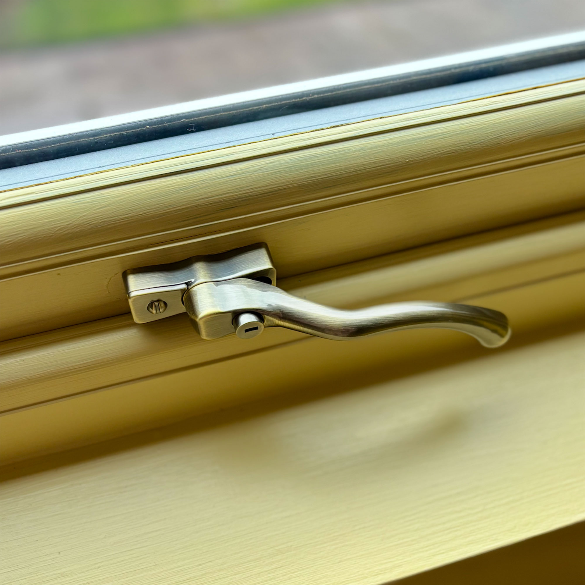 Close up of brass coloured window latch