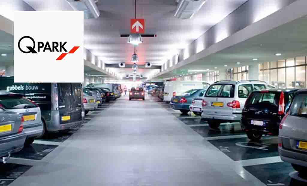 q-park logo placed over an image of cars parked in a parking lot