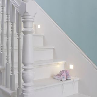 Staircase in hallway with square spotlights