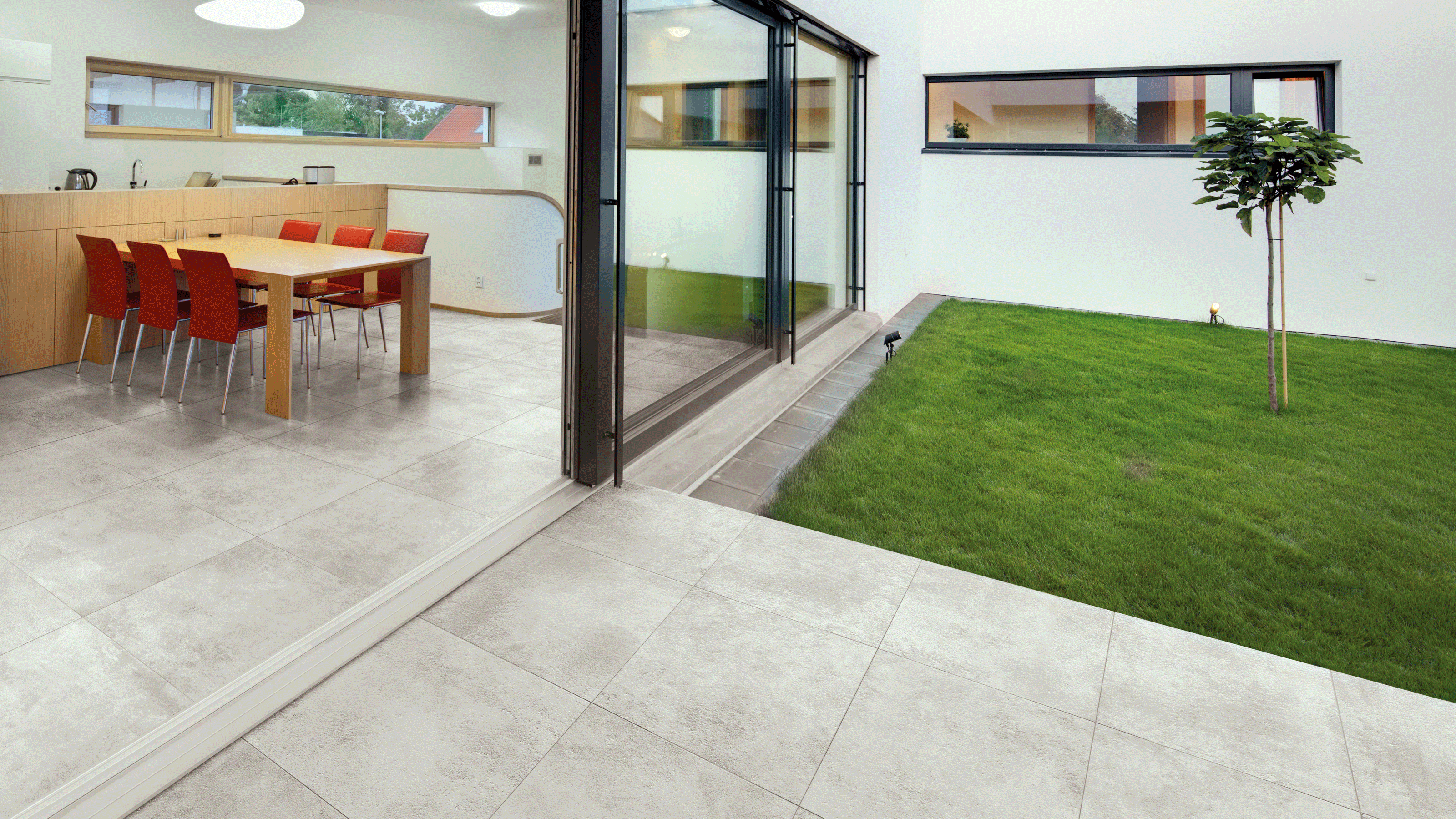 Pale grey Metro 02 patio pavers leading from interior to outside