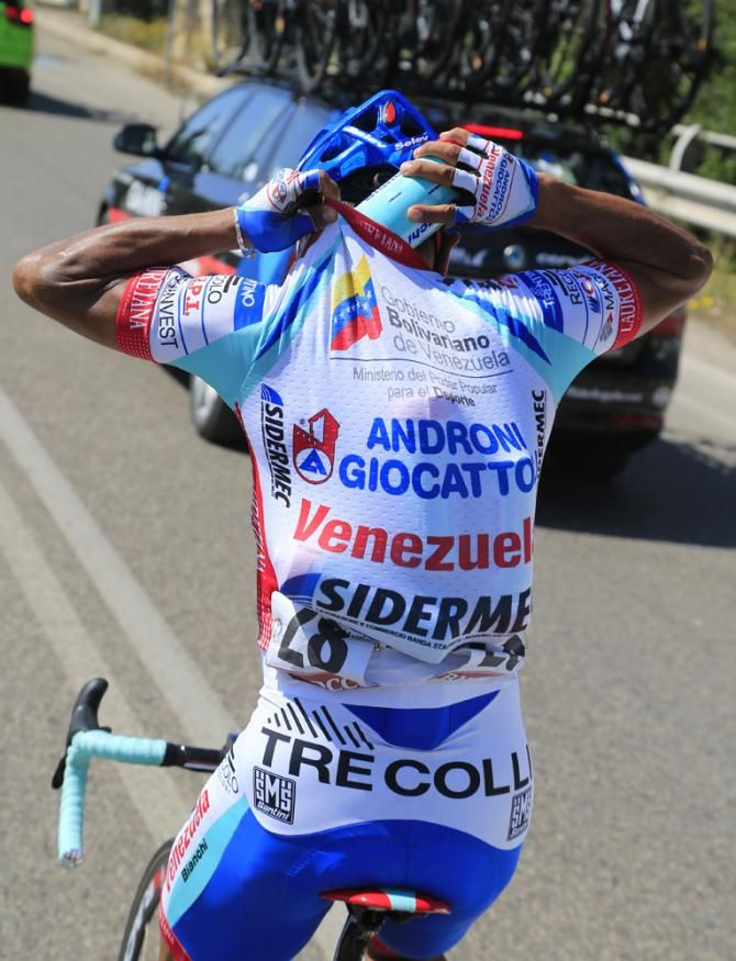 Miguel Rubiano (Androni Giocattoli) loads up with bottles to deliver to his teammates