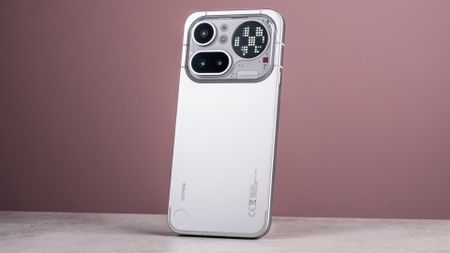 The Nothing Phone (4a) Pro's back showing its aluminum unibody, camera module and Glyph Matrix, which is midway through showing a moving glyph.