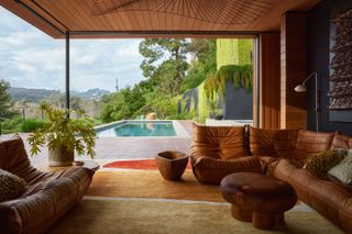 The living spaces open up to the pool terrace