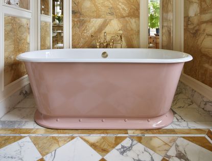 pink bath in an opulent bathroom with a checkerboard floor