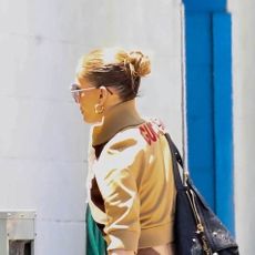 Jennifer Lopez wearing a tan jacket and brown leggings