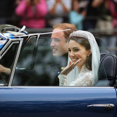 Prince William, Duke of Cambridge and Catherine, Duchess of Cambridge drive from Buckingham Palace in a decorated sports car on April 29, 2011 in London, England. The marriage of the second in line to the British throne was led by the Archbishop of Canterbury and was attended by 1900 guests, including foreign Royal family members and heads of state. Thousands of well-wishers from around the world have also flocked to London to witness the spectacle and pageantry of the Royal Wedding.