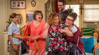 the cast of one day at a time all laughs and hugs each other in the netflix reboot