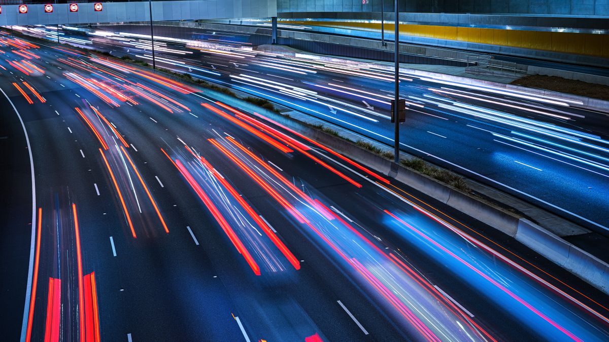 Traffic moving really fast on a motorway at night