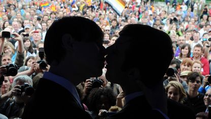 Two men kiss during the Rainbow Pride Parade, a march for the human rights of non-heterosexual people and the celebration of LGBT (lesbian, gay, bisexual, transgender) pride, in Bratislava on