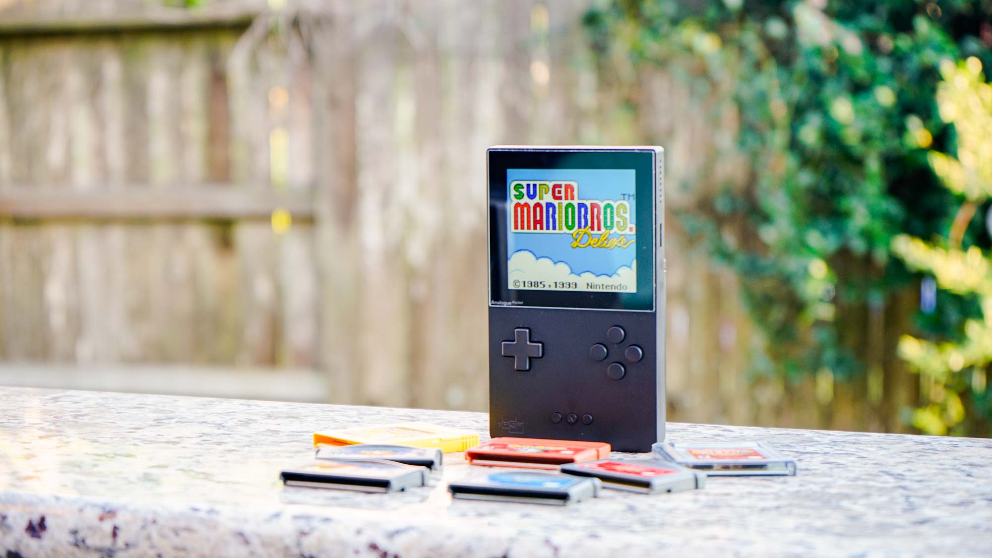 Hands Holding Small Handheld Game Pokemon on Gameboy Colour Stock