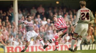 SOUTHAMPTON - APRIL 13: Matthew Le Tissier of Southampton shoots at goal as Ryan Giggs of Manchester United makes a challenge during the FA Carling Premiership match between Southampton and Manchester United held on April 13, 1996 at The Dell, in Southampton, England. Southampton won the match 3-1. (Photo by Shaun Botterill/Getty Images)