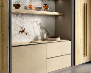 Golden cabinetry and countertops, marble splashback