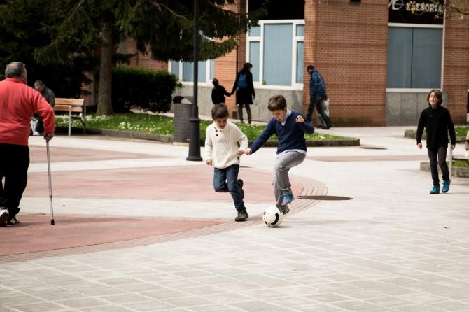 The atmosphere at the finish line is always loose and fun - some young fans enjoy an impromptu soccer match