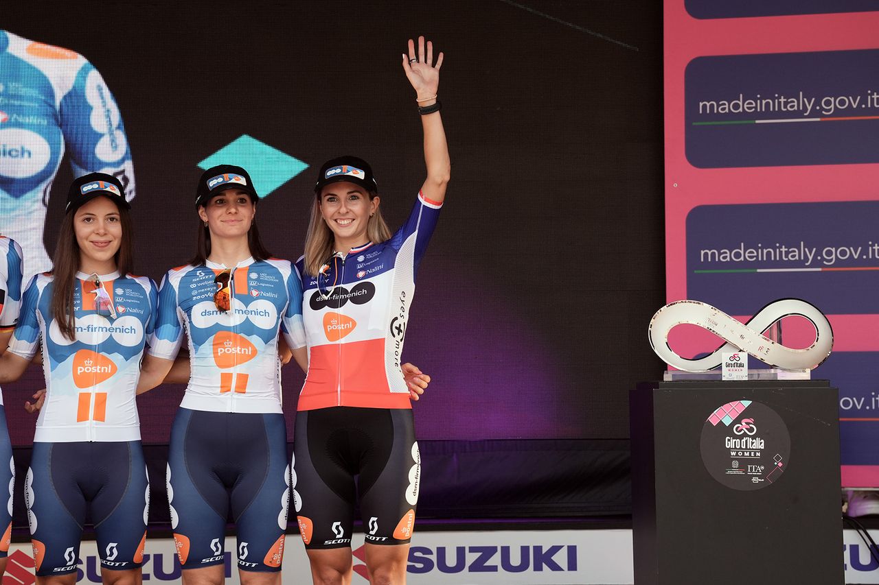 Juliette Labous waves to the crowds at on stage at the 2024 Giro d'Italia Women at the teams presentation at the Piazza della Loggia in Brescia