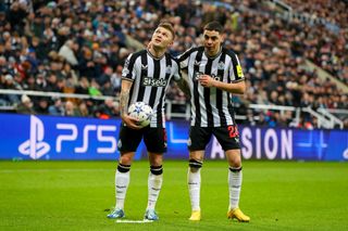 Kieran Trippier of Newcastle United and Miguel Almiron of Newcastle United during the UEFA Champions League match between Newcastle United FC and AC Milan at St. James Park on December 13, 2023 in Newcastle upon Tyne, United Kingdom
