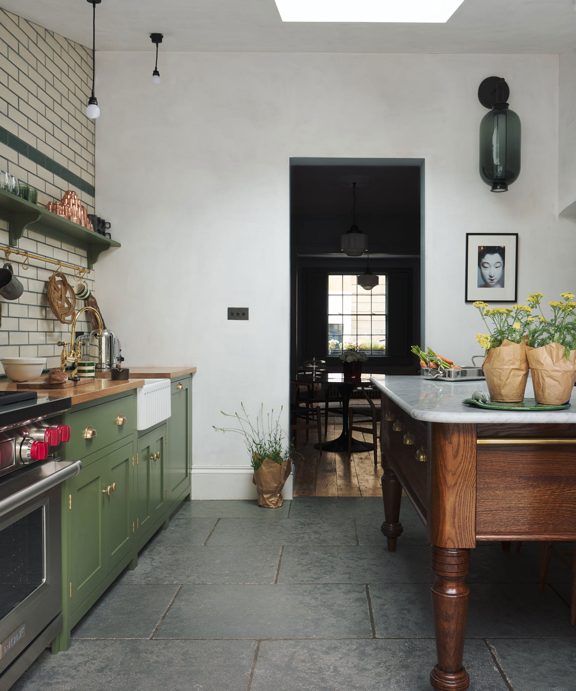 green Shaker kitchen with high ceilings and freestanding wooden kitchen island with marble worktop