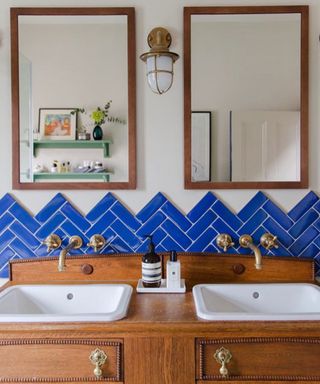 vintage style bathroom with antique vanity unit and bright cobalt blue splashback tiles