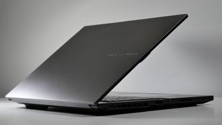 Asus Vivobook Pro 15 (N6506, 2025) on a white table, open at an angle, highlighting the lid and hinge.