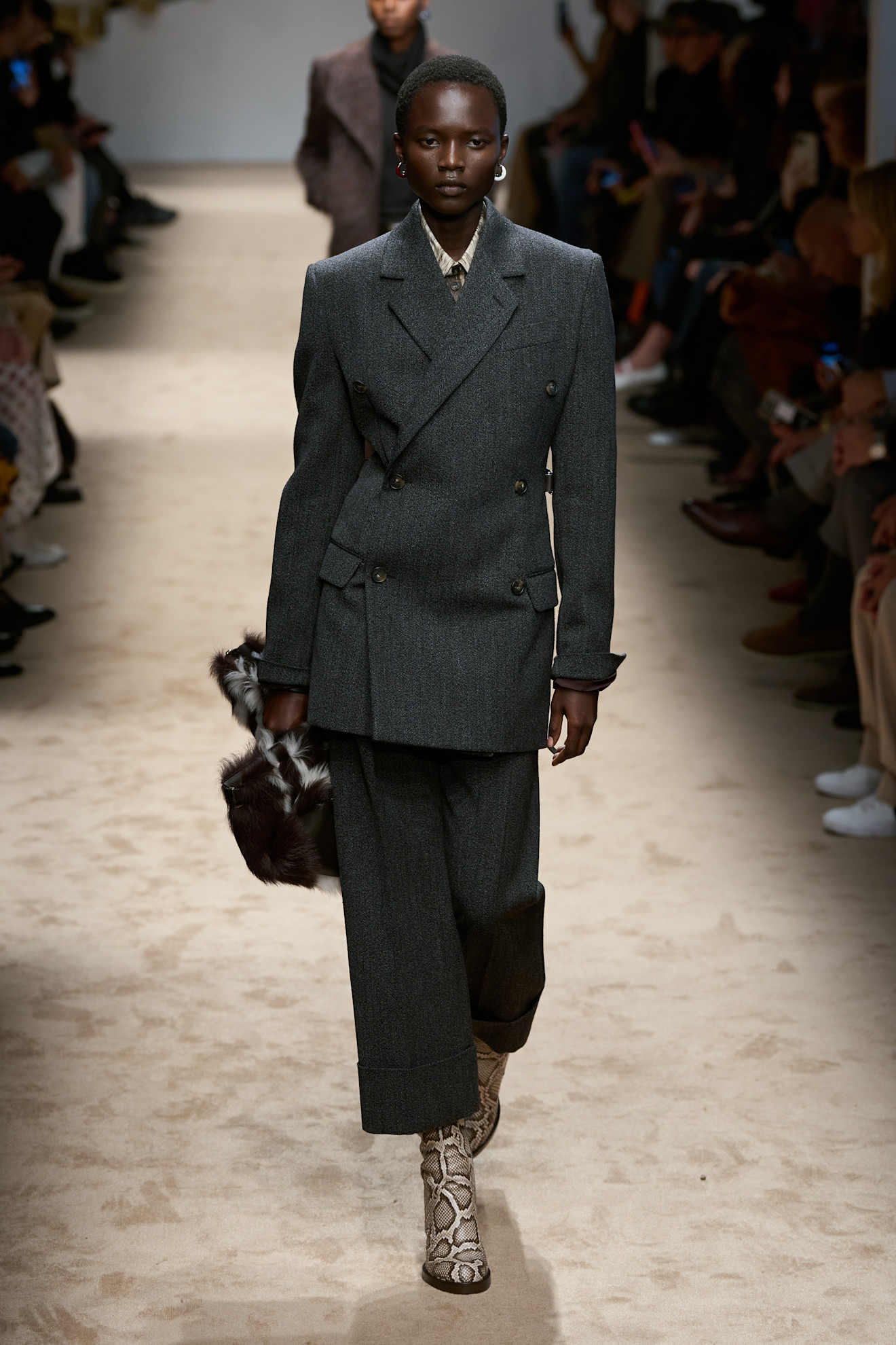 A model wears brown boots on Tod&#039;s autumn/winter 2025 runway